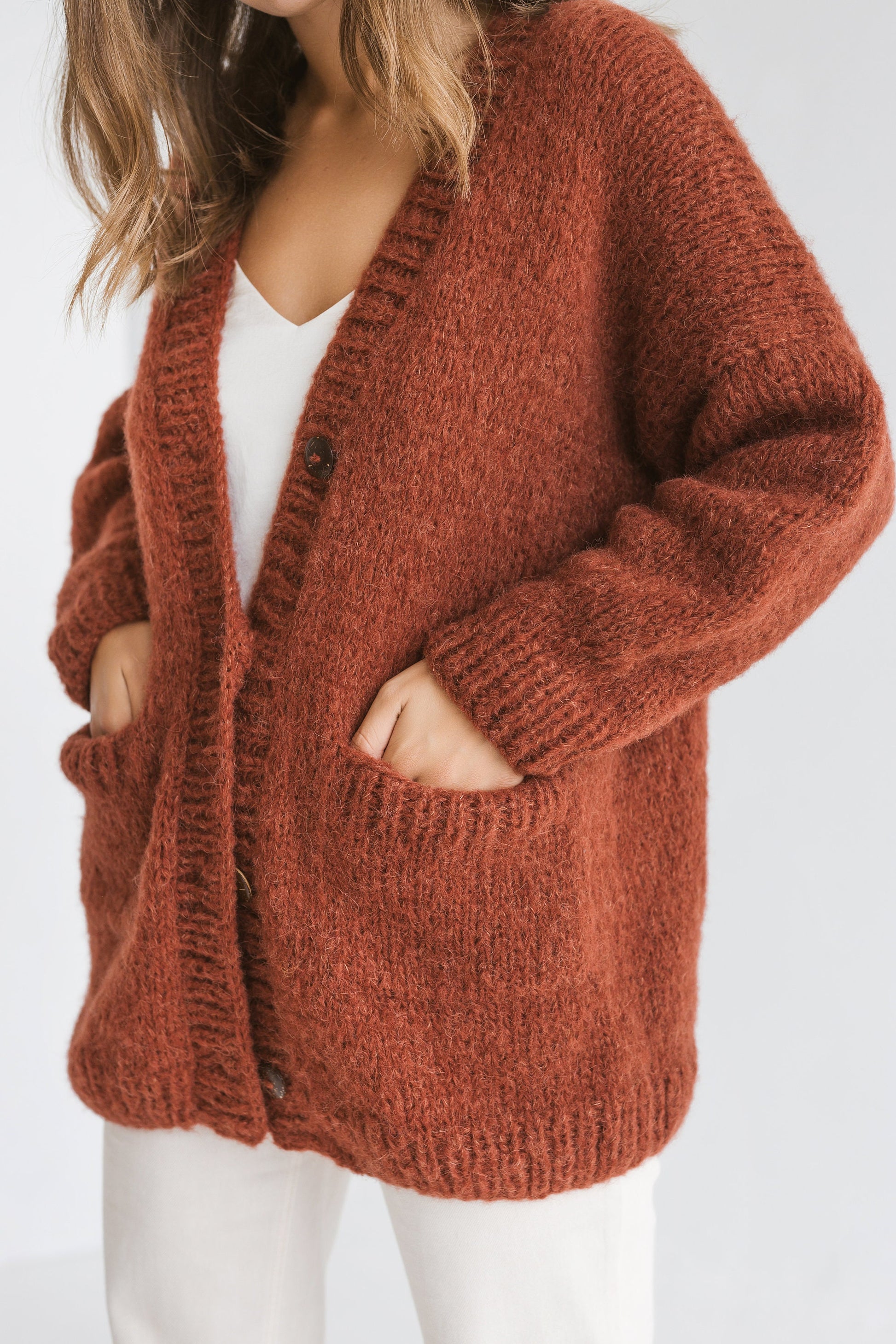 Rust cable knit alpaca wool cardigan with buttons, orange slightly oversized buttoned woolen sweater with pockets, ginger chunky knitted